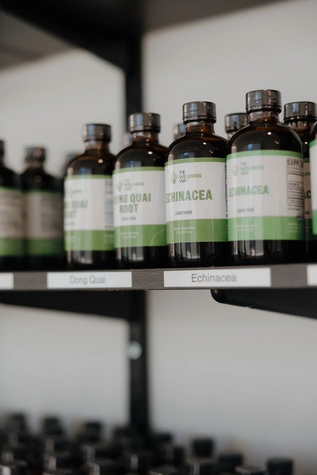 Wellness Way branded liquid herbal supplements on the clinic shelf