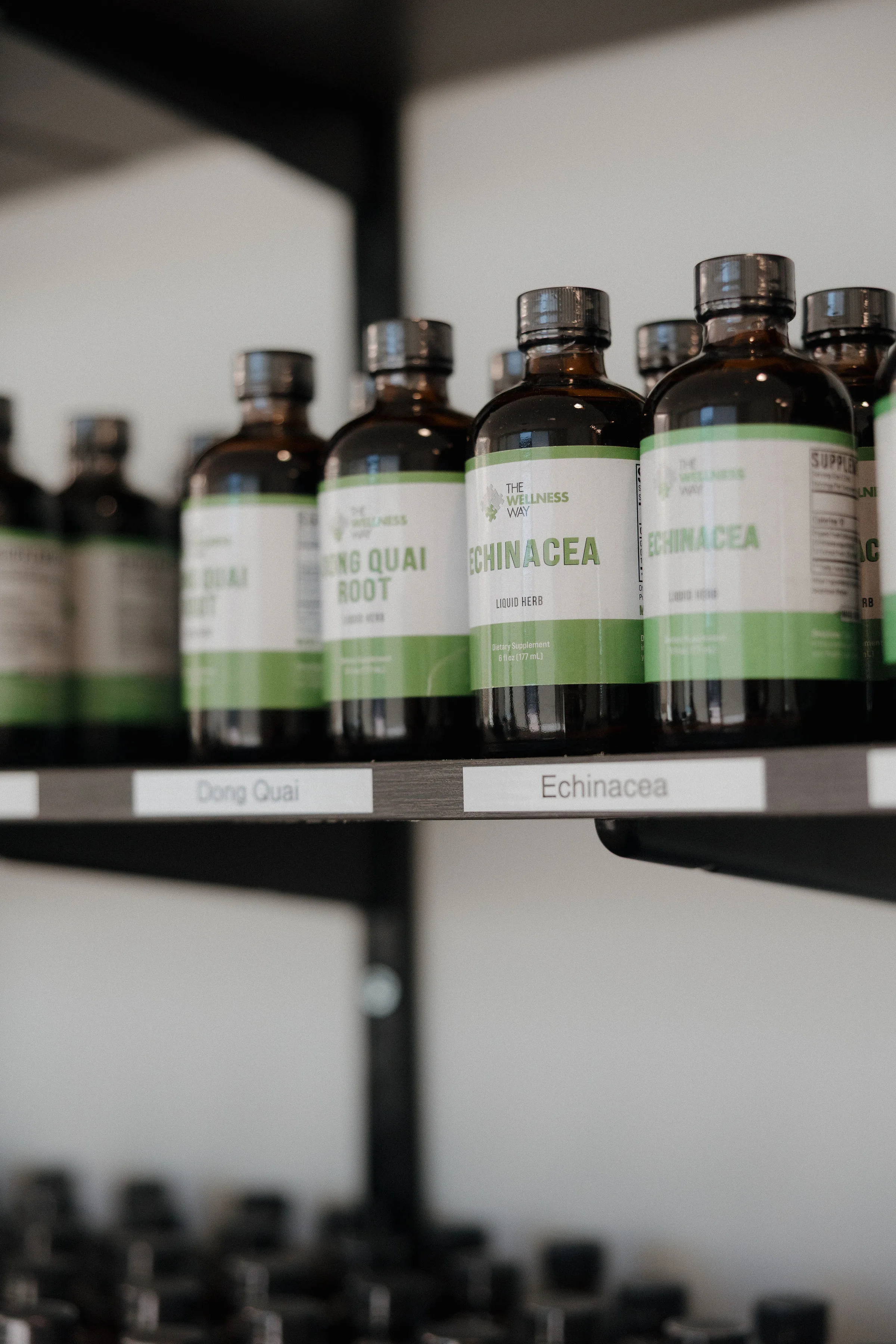 Wellness Way branded liquid herbal supplements on the clinic shelf