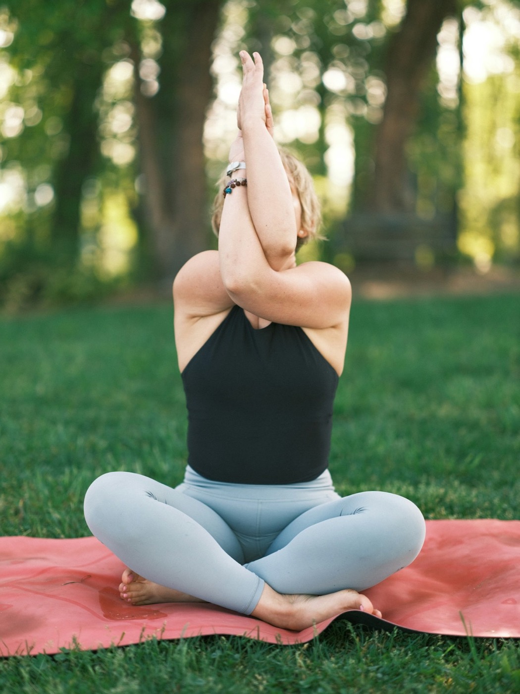 Person doing a gentle outdoor back stretch — supportive movement for joint and muscle health