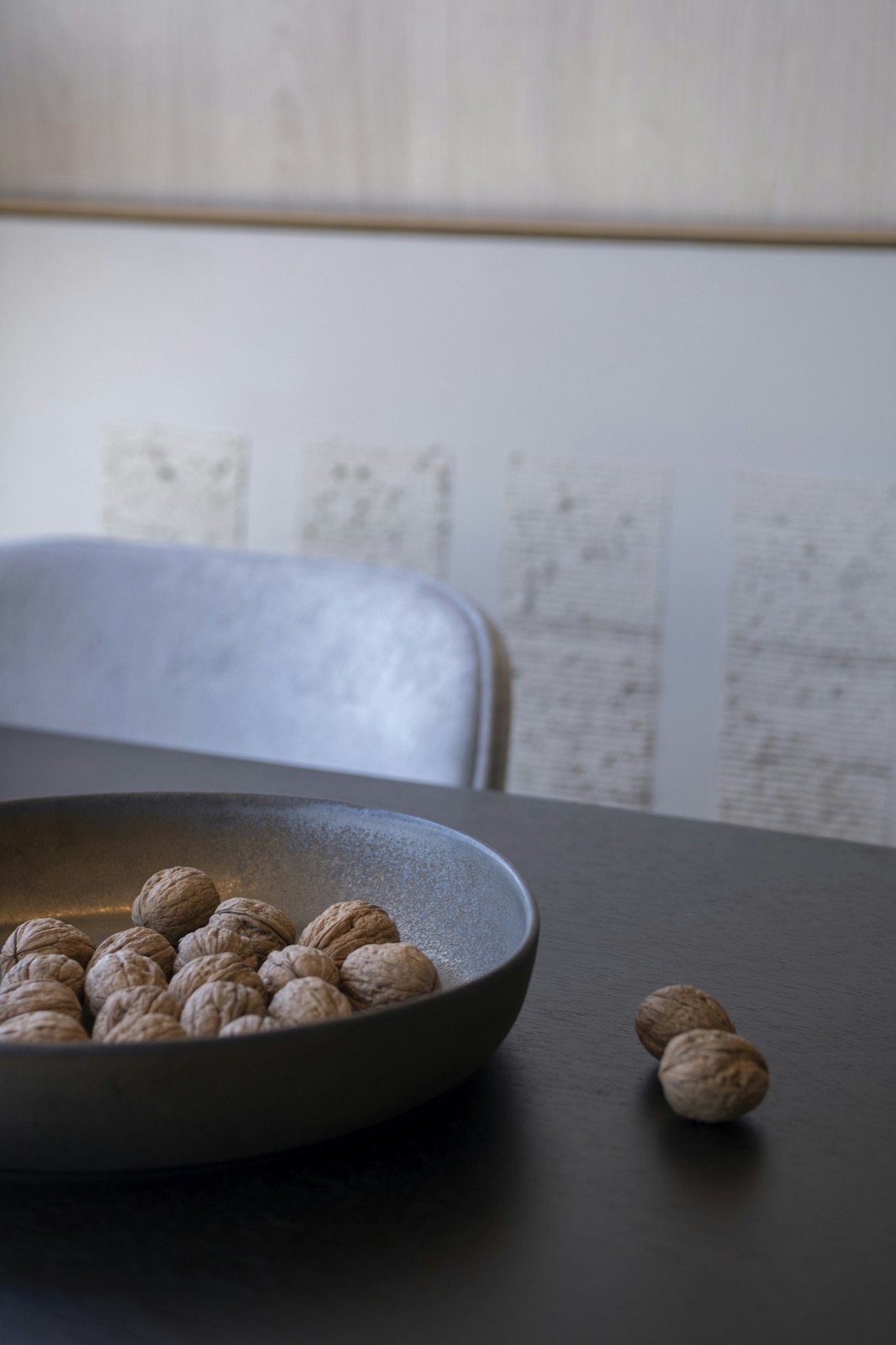 Bowl of walnuts on a dark wooden table — selenium-rich whole foods that support thyroid health