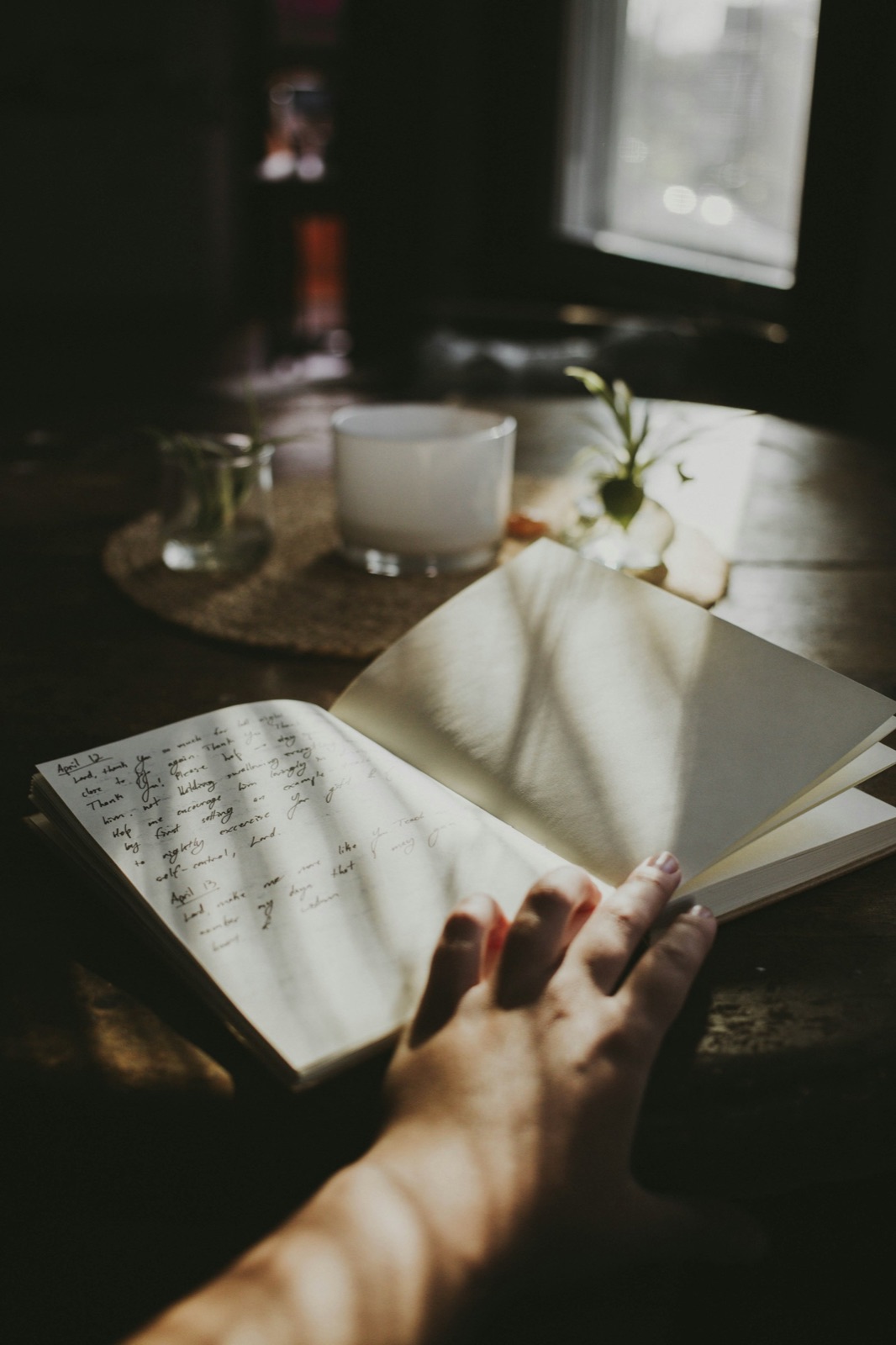 Open journal on a wooden table in soft morning light — calm reflection and mental wellness