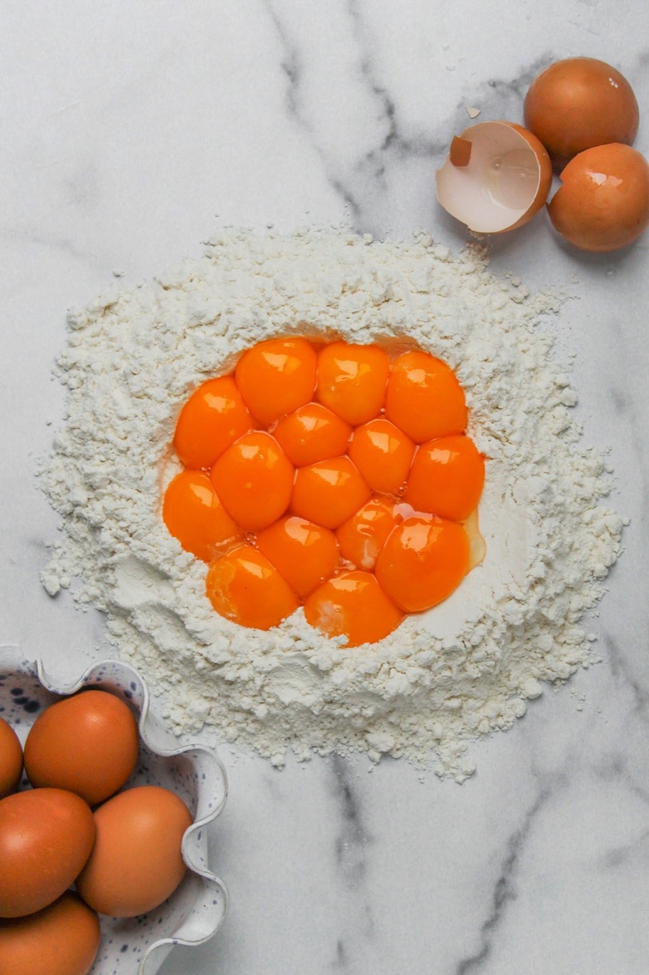 Eggs and flour on a marble surface — common food allergens