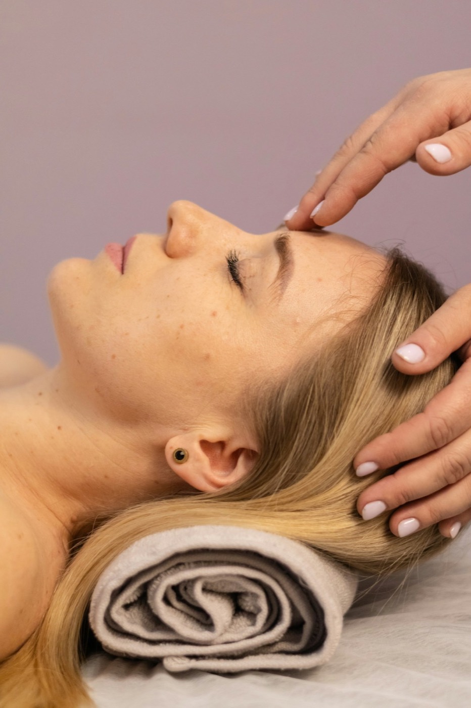 Gentle craniosacral therapy hands on head in a calm setting