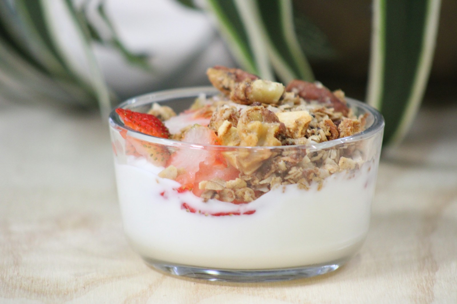 Yogurt parfait layered with fresh fruit and granola in a bowl