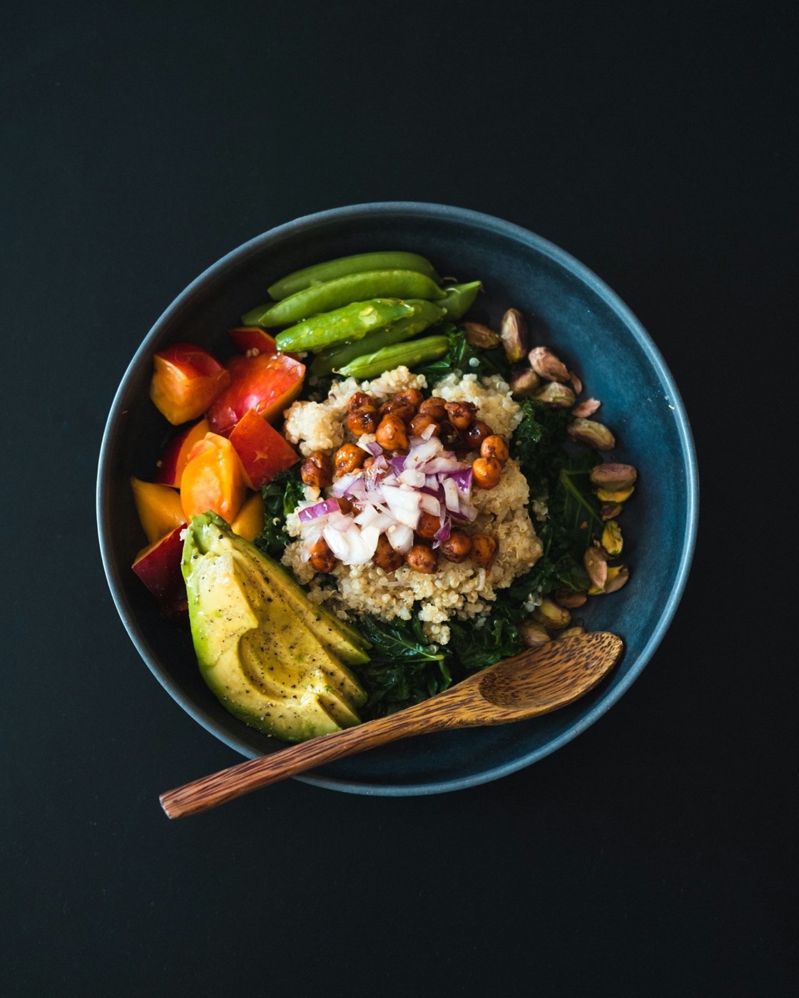 Colorful Buddha-style grain bowl with leafy greens, quinoa, and fresh produce